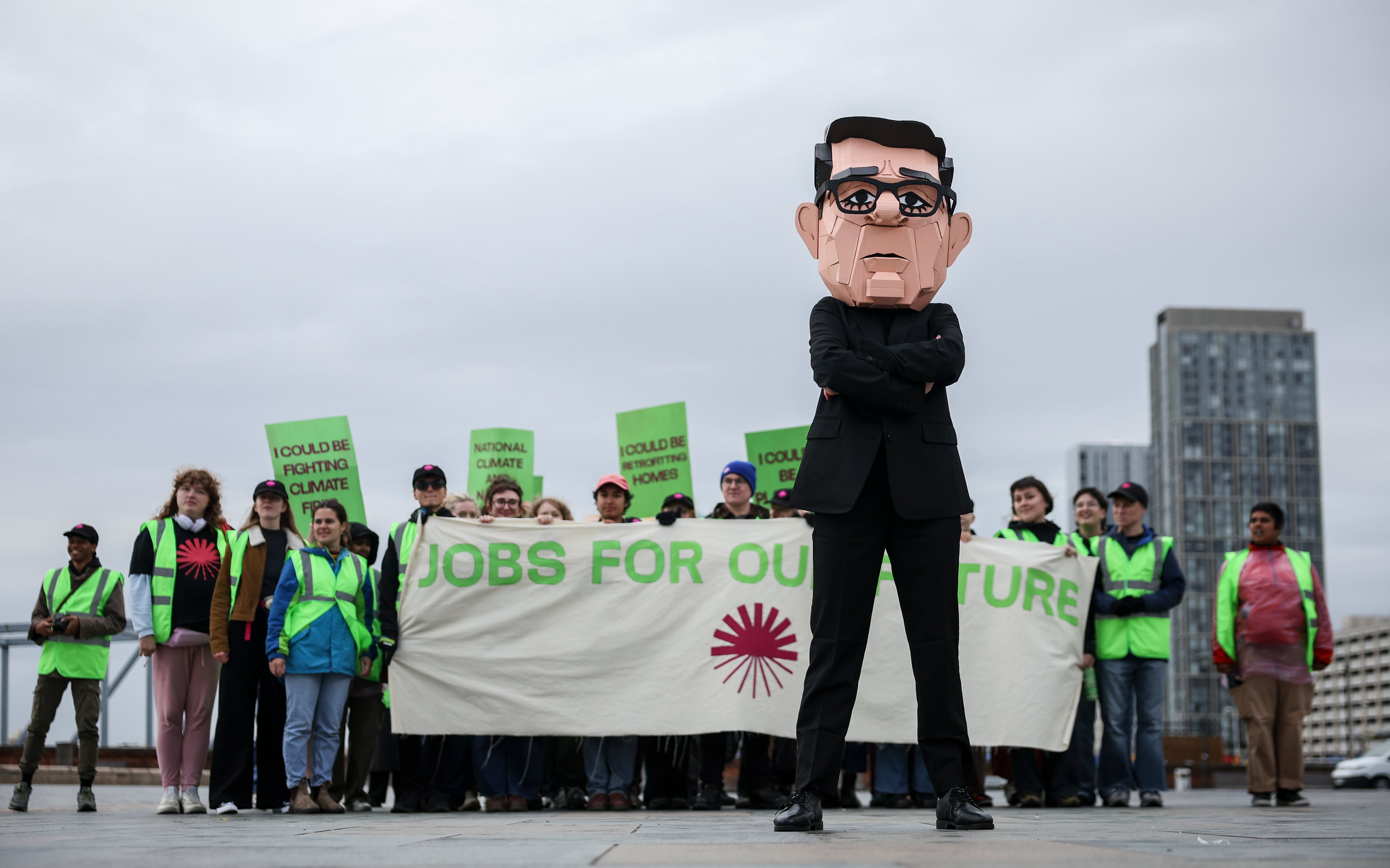 A protester wears papier mache head of UK Prime Minister Andy Burnham during a jobs demonstration. Getty Images