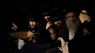 Ultra-Orthodox Jews buy chickens for the Kaparot ritual in Bnei Brak, Israel. AP