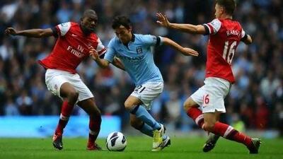 David Silva, the Manchester City midfielder, is shut down by Abou Diaby and Aaron Ramsey, the Arsenal duo. Laurence Griffiths / Getty Images