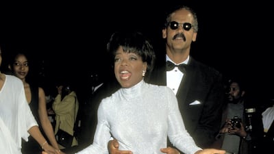 Oprah Winfrey wears a full light-blue skirt with a silver top to attend the 1995 Essence Awards with Stedman Graham at the Paramount Theatre in New York City on May 12, 1995. Getty Images