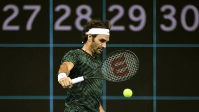 Roger Federer hits a backhand during a training session. Julian Smith / EPA