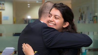 Sara Dube of Jumeirah English Speaking School hugs Ian Thurston, the deputy head of KS5 at JESS. Sara scored a perfect 45 in her IB test results. Navin Khianey for The National