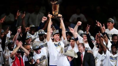 Dirk Nowitzki, cente, of the Dallas Mavericks celebrates with teammates after winning the NBA Finals.