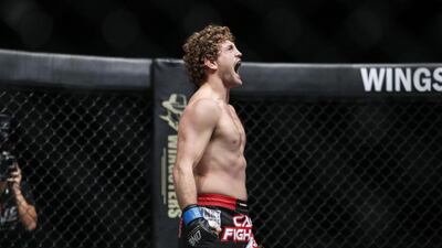 American Ben Askren celebrates after defeating Japan’s Nobutatsu Suzuki to take the welterweight world title at the One Fighting Championship. Antonie Robertson / The National