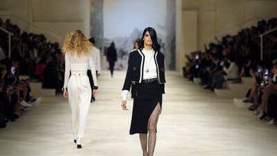 A side-slashed skirt was paired with fishnet tights