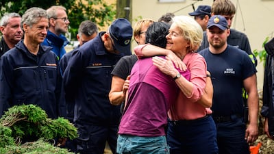 EU Commission President Ursula von der Leyen embraces a resident of Crna na Koroskem as she visits flood-hit areas of Slovenia. AFP