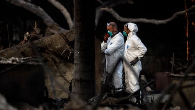 A search team works at a home destroyed by the Eaton Fire in Altadena. AP