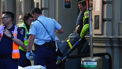 A woman is placed onto a gurney by paramedics in Sydney, Australia. EPA