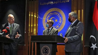 Greek Foreign Minister Nikos Dendias, left, has given his support to the interim government in Libya. AFP
