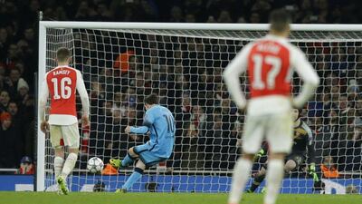 Barcelona's Lionel Messi,shoots and scores his sides second goal from the penalty spot during the Champions League round of 16 first leg soccer match between Arsenal and Barcelona at the Emirates stadium London, Tuesday, Feb. 23, 2016. (AP Photo/Matt Dunham)