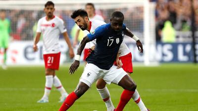 France's Moussa Sissoko, front, fights for the ball with Turkey's Mahmut Tekdemir during their Euro 2020 Group H qualifying match in Paris. AP