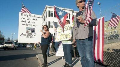 Lisa Taurasi, Lucy Rodriguez and Luis Barbosa, all of Worcester, protest outside Graham Putnam & Mahoney Funeral Parlors in Worcester. They do not want Tamerlan Tsarnaev buried in the United States.