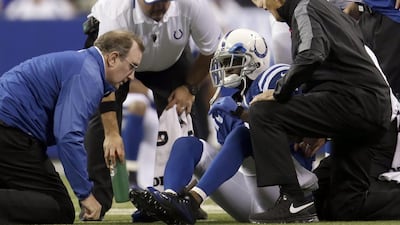 Trainers tend to Indianapolis Colts wide receiver Reggie Wayne after he injured his knee last week. AJ Mast / AP Photo