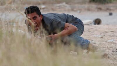 A GNA troop tries to get the attention of a fellow fighter during the battle. Reuters
