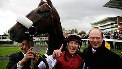 Frankie Dettori celebrates Casamento’s win with trainer Michael Halford, right.