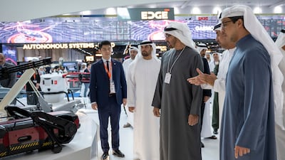 Sheikh Mohamed and Sheikh Mansour view an exhibit at a booth