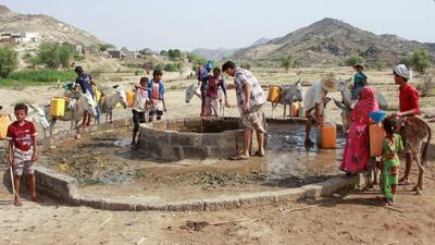 Yemenis fill their jerrycans carried by donkeys with water from a cistern at a make-shift camp for the internally displaced in the northern Hajjah province. AFP