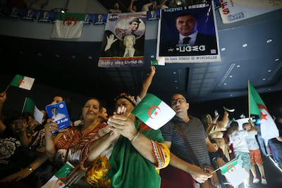 Supporters of presidential candidate Youcef Aouchiche attend a rally on the last day of campaigning on Tuesday. AP