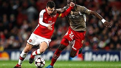 Arsenal's captain Cesc Fabregas, left, is a vocal supporter of Arsene Wenger's philosophy.