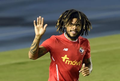 Panama's Roman Torres waves to supporters during a training session in Panama City. Rodrigo Arangua / AFP