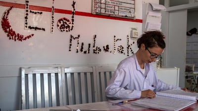 Nurse Elisa Venturella counts last week's admissions at the hopsital: a total of 95, including 28 patients from this week's attacks in Kabul. On the wall, a rose petal-decorated "Eid Mubarak" greets the new patients. Stefanie Glinski for The National