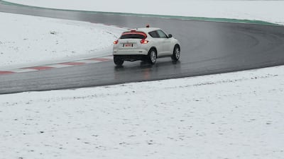 Race control check the track surrounded by snow before testing. Albert Gea / Reuters