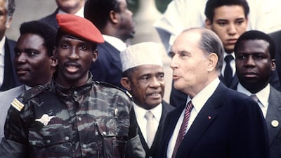 Sankara in paratrooper uniform with then-French president Francois Mitterrand in Vittel, France, 1983. AFP