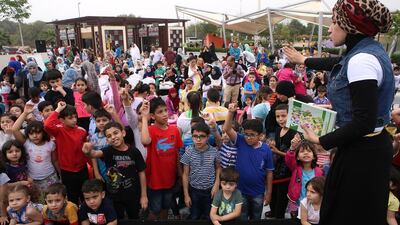 Children participate in a quiz at the "Language of Happiness" event organised by Abu Dhabi Municipality to encourage reading in Arabic on Wednesday in Delma Park. Ravindranath K / The National