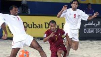 Qambar Sadeqi of the UAE (in white) and Madjer of Portugal clash on the first day of the FIFA Beach Soccer World Cup.