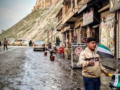A boy waves the new Syria flag outside Aleppo Citadel. Photo: Paul McCann / Halo