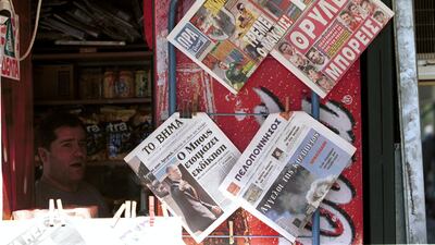 A Greek news stand in Athens with local sports papers previewing Olympiakos v Manchester United whilst the newspapers report the terrorist attack on the United States in September, 2001. Getty