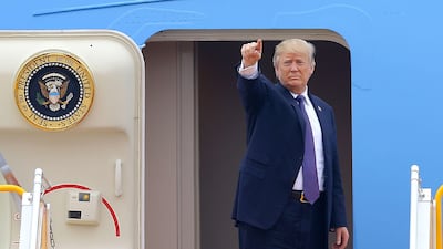 US president Donald Trump gestures before boarding Air Force One to travel to the Philippines, at the airport in Hanoi on November 12, 2017. Minh Hoang / AFP
