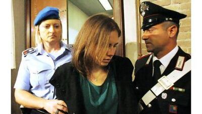 Amanda Knox, centre, is escorted as she arrives for an appeal hearing at the court in Perugia, Italy yesterday. Antonio Calanni / AP Photo