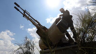 A fighter loyal to Libya's Government of National Accord mans a position west of the city of Aziziah, south-west of Tripoli. AFP/Mahmud Turkia