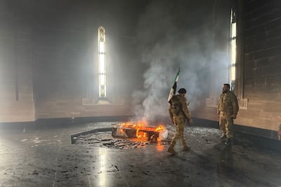 The once-revered marble monument, located in the elder Assad's hometown, was stormed and set ablaze by the rebels. AFP