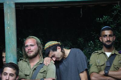 Mourners at the funeral of one of the four Israelis killed in Tuesday's attack near the settlement of Eli. AFP