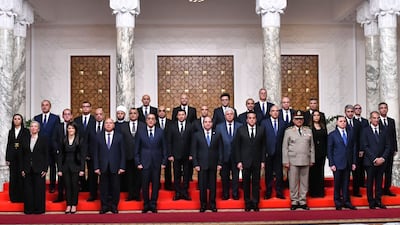 Egyptian President Abdel Fattah El Sisi, centre, poses with Egypt's new Cabinet, led by Prime Minister Mostafa Madbouly, fourth left, at Al Ittihadiya Palace in Cairo on Wednesday. AP