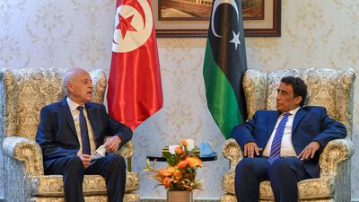 A handout picture provided by the Tunisian Presidency Facebook Page shows Tunisian President Kais Saied (L) meeting with Libya's new Head of the Presidential Council, Mohammad Menfi, in the Libyan capital Tripoli. AFP