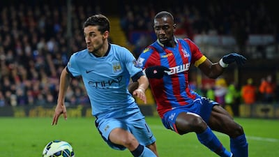Manchester City midfielder Jesus Navas vies with Crystal Place's Yannick Bolasie on Monday night during their Premier League contest at Selhurst Park. Glyn Kirk / AFP