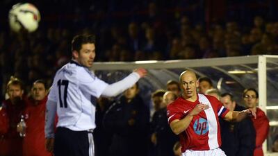 British Army player Keith Emmerson, right, passes the ball past Bundeswehr player Marcus Geogi during the "Game of Truce" on Wednesday in Aldershot, England. Ben Stansall / AFP