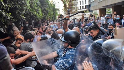 Protesters scuffle with security forces as they attempt to break into the residence of Lebanon's interior minister in the Qoraitem neighbourhood of western Beirut.