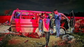 Syrian forensic investigators inspect the minibus targeted on the Masyaf Bridge in Homs province. AFP