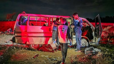 Syrian forensic investigators inspect a civilian vehicle targeted on Masyaf Bridge in Homs province on September 30. AFP