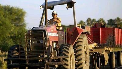 A man drives a tractor in Paraguay. A reduction in farming subsidies in the US could help developing economies. Noah Friedman-Rudovsky / Bloomberg