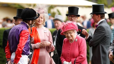 Britain's Queen Elizabeth speaks with a jockey at Ascot. Reuters
