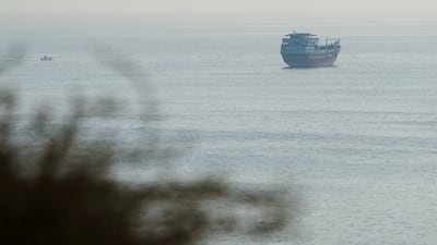 A ship waits to sail through the Strait of Hormuz. Two vessels transited the waterway on Thursday, Kpler data shows. Reuters