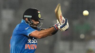 India's Virat Kohli plays a shot during the Asia Cup T20 cricket tournament match between India and Pakistan at the Sher-e-Bangla National Cricket Stadium in Dhaka on February 27, 2016. / AFP / MUNIR UZ ZAMAN
