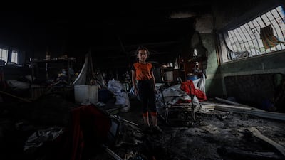 Palestinians inspect the damage after Israeli troops bombed Musa bin Nasir School, sheltering displaced people, in Gaza city's Daraj neighbourhood with two kamikaze drones on May 20