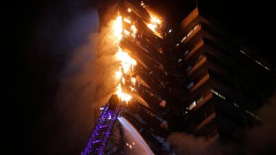 Flames engulf the iconic Enel building in downtown Santiago. AFP