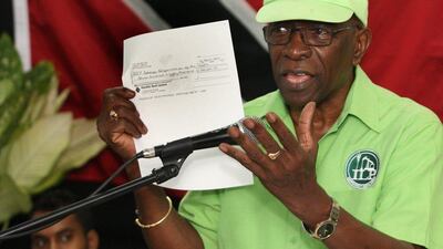 Former Fifa vice president Jack Warner holds a copy of a check while he speaks at a political rally in Marabella, Trinidad and Tobago, Wednesday, June 3, 2015. (Photo/Anthony Harris)